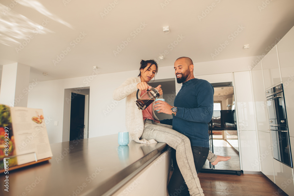 Couple having coffee in kitchen