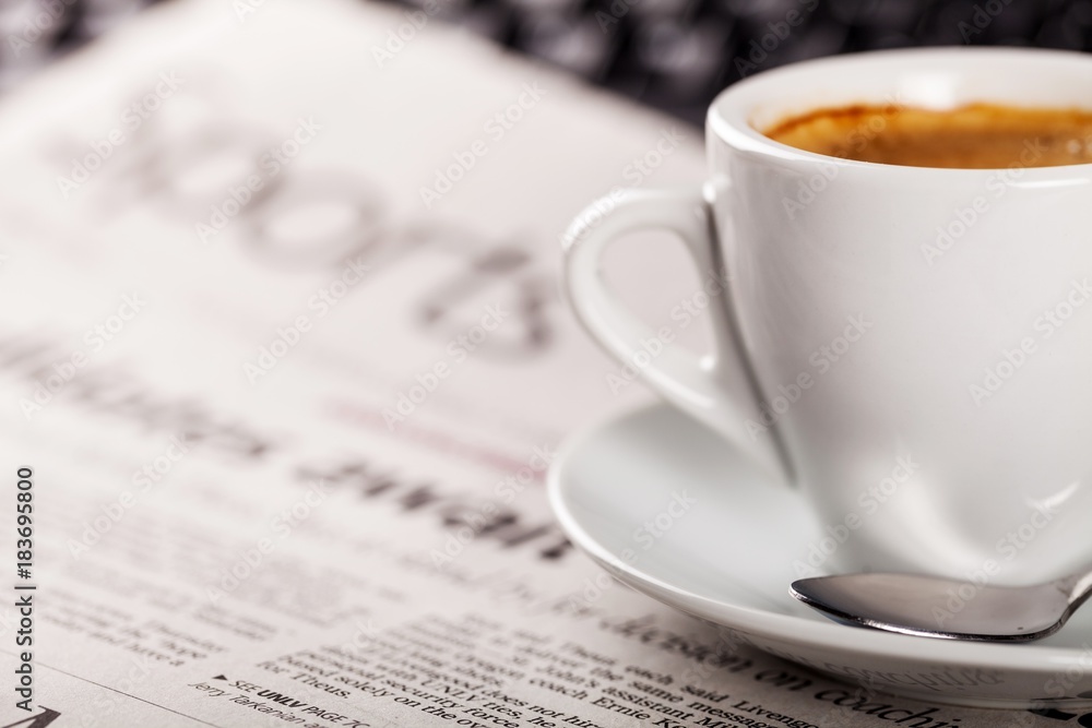 Cup of Coffee on Newspaper and Keyboard