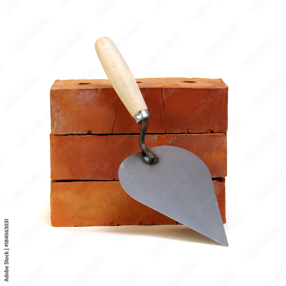 Brick and trowel on a white