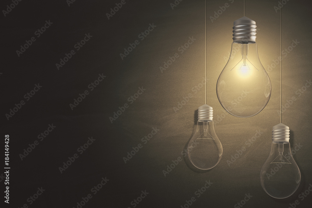 Glowing lightbulbs on chalkboard background