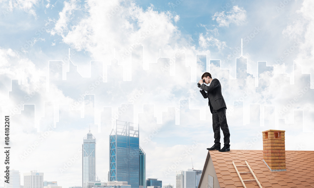 Businessman standing on roof and looking in binoculars. Mixed media