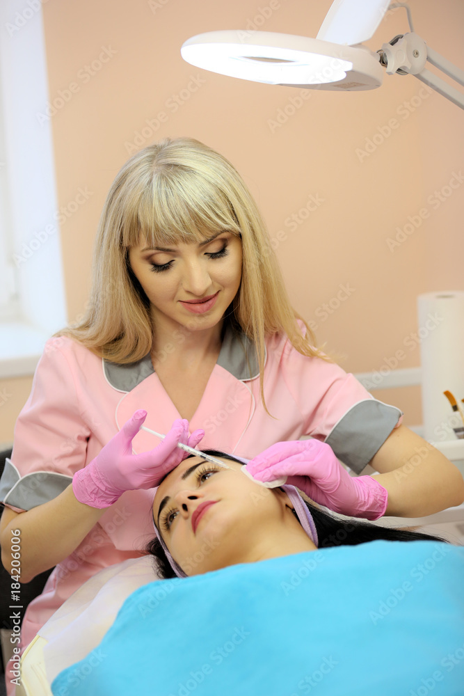 The doctor cosmetologist makes the Botulinum Toxin injection. Procedure for tightening and smoothing