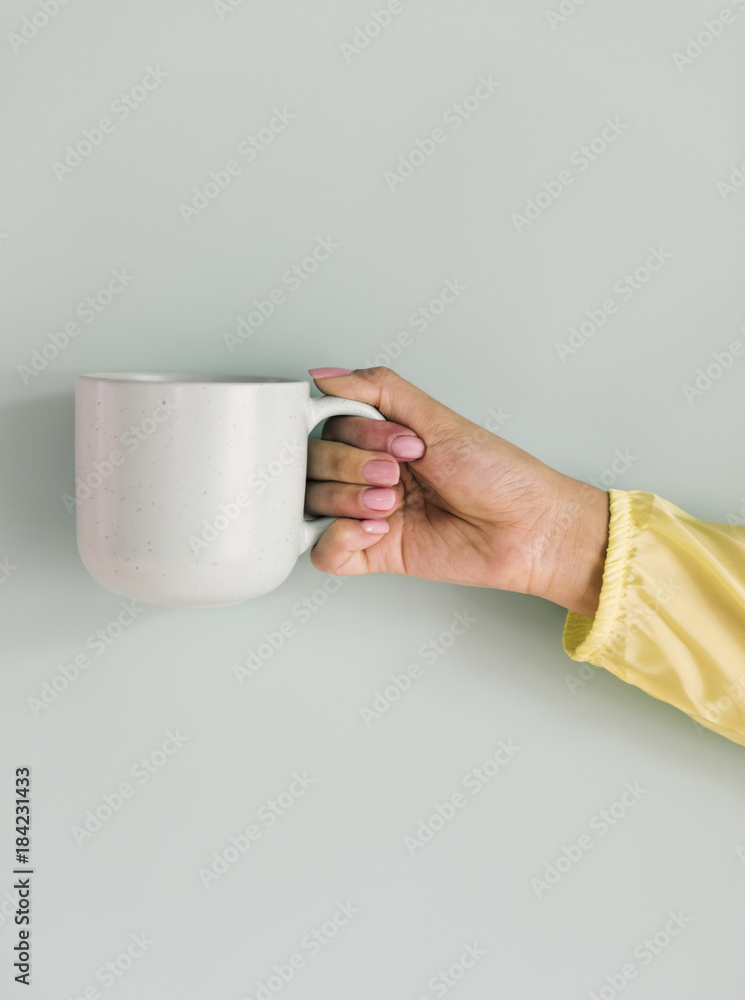 Closeup of hand holding coffee cup