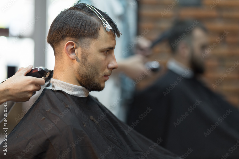 Young handsome man in barbershop