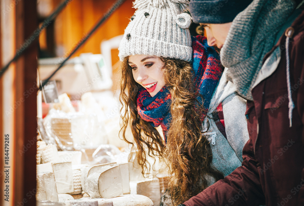 Christmas market shopping, couple choosing things for buying