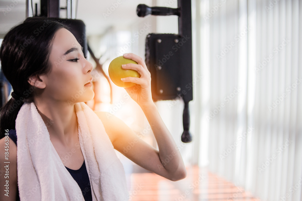 sport asian woman in workout costume  in action with blur fitness background health concept