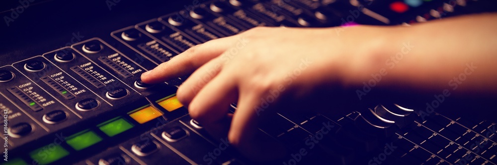 Cropped hand of woman using sound mixer