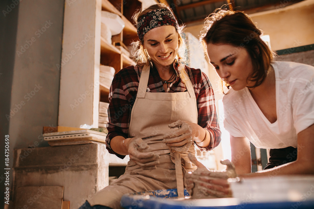 Woman teaching the art of pot making