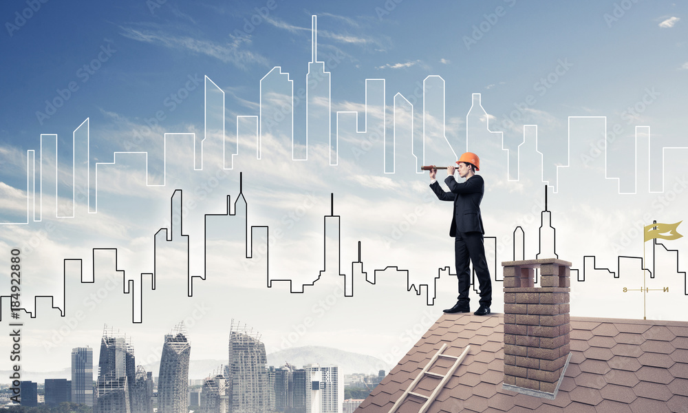 Engineer man standing on roof and looking in spyglass. Mixed med