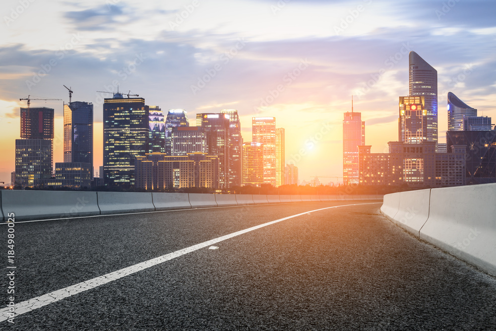 Asphalt highway and modern city buildings in hangzhou qianjiang new city at sunset