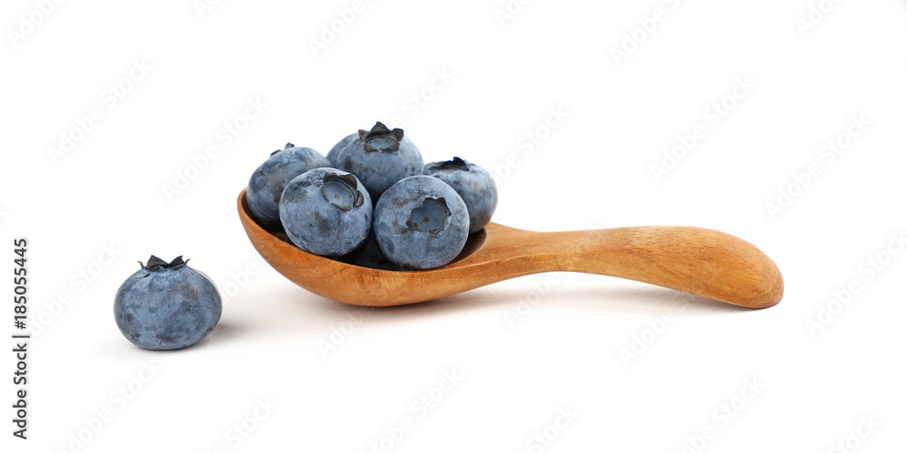 Fresh blueberry in wooden spoon isolated on white