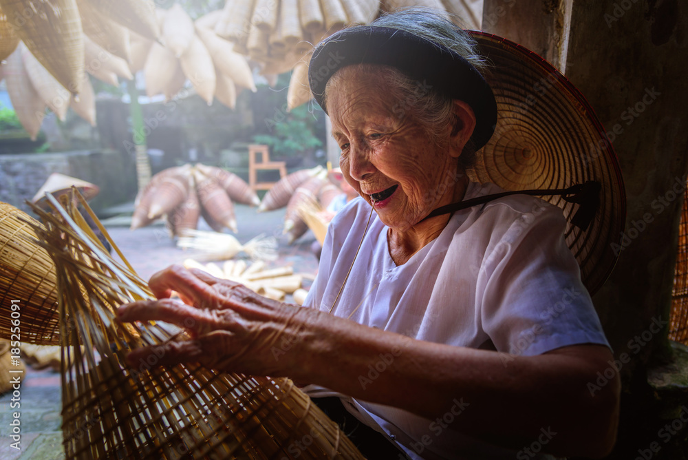 Vietnamese fishermen are doing basketry for fishing equipment at morning in Thu Sy Village, Vietnam.