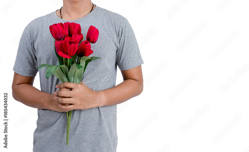 Isolated Asian young man holding the red tulip flower to give it to his girlfriend on Valentines Da