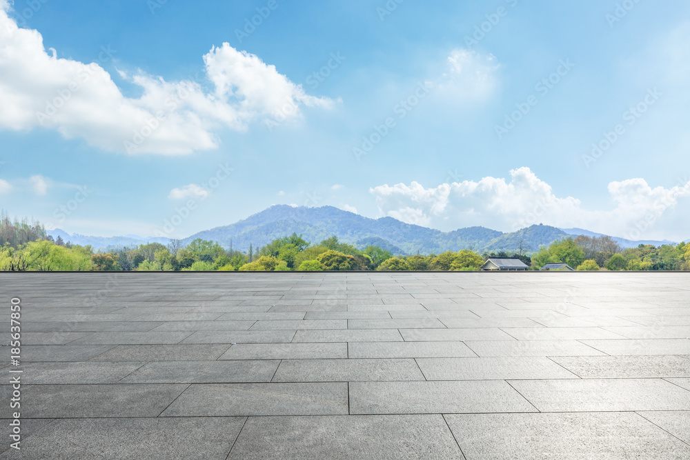 empty square floor and green mountain nature landscape in city park