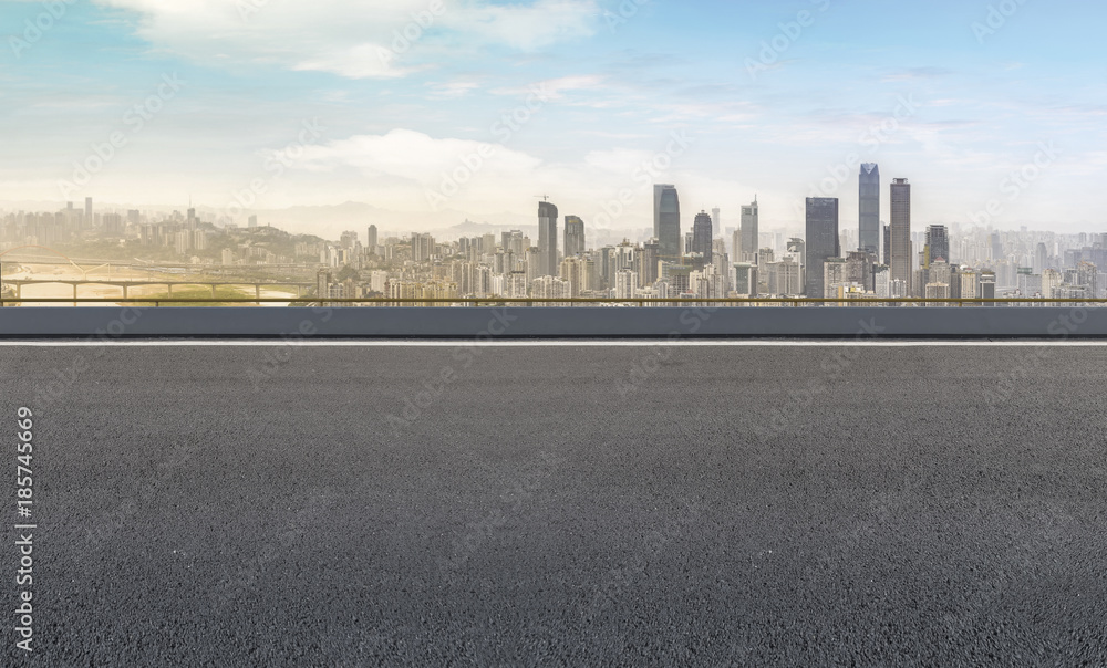 Road pavement and city skyline