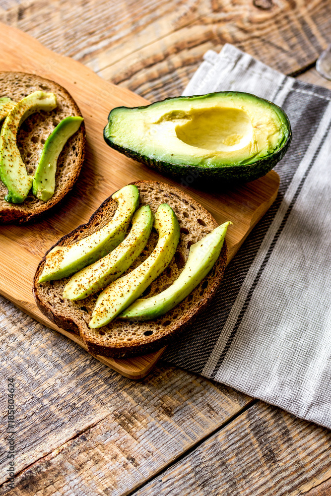 making sandwiches with avocado healthy organic food top view