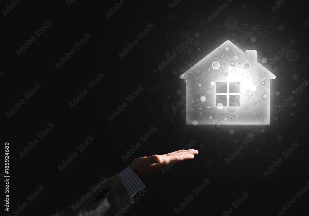 Conceptual image with hand pointing at house or main page icon on dark background