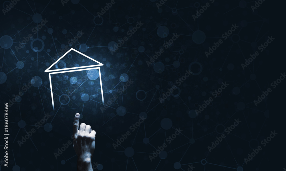 Conceptual image with hand pointing at house or main page icon on dark background