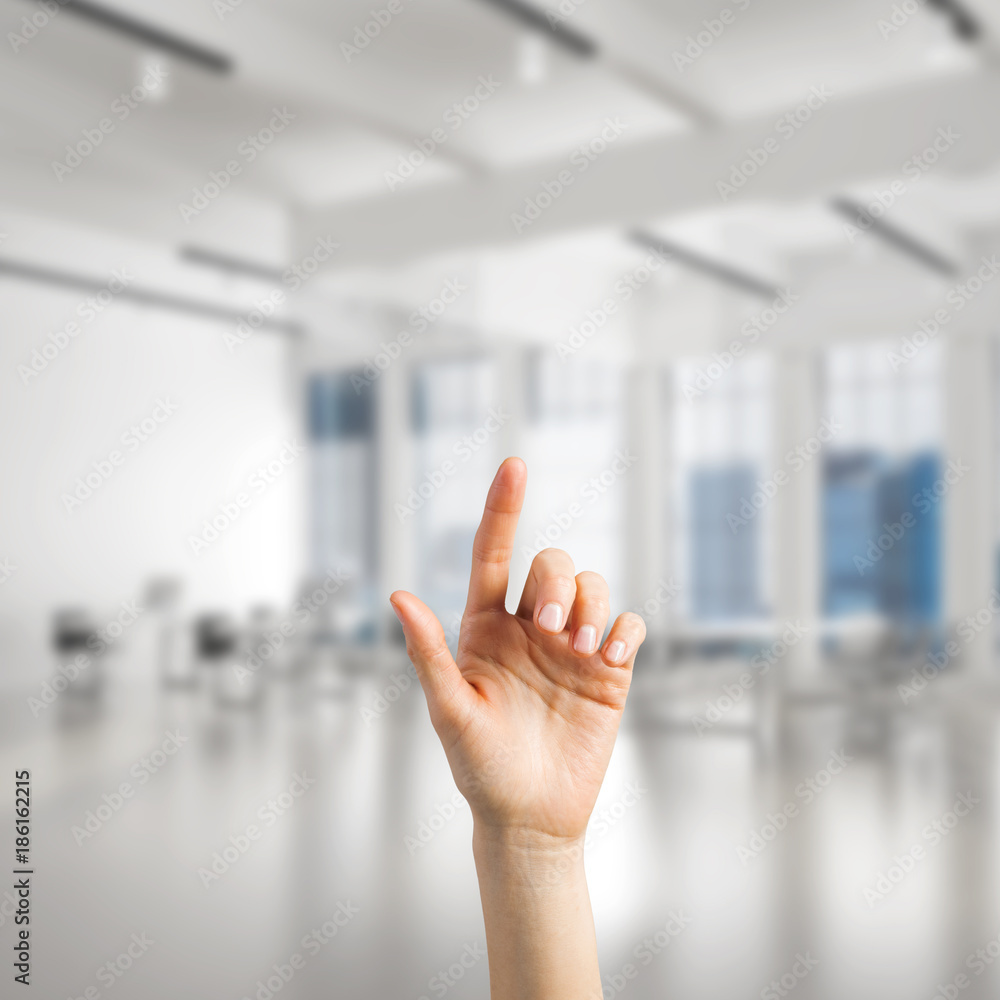 Choosing gesture of person in elegant modern interior in sunshine light