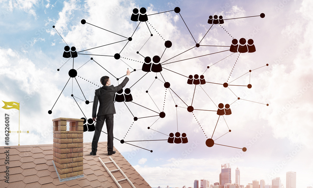 Businessman on house roof presenting networking and connection concept. Mixed media