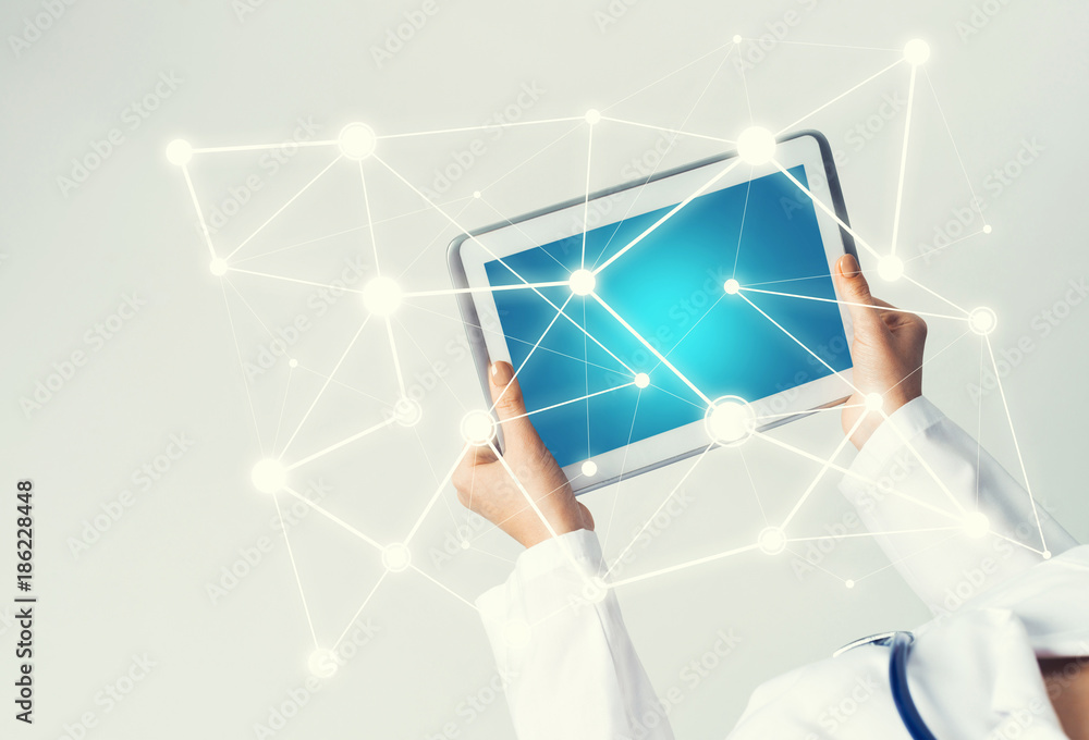 Close of female doctor hands working with tablet pc computer