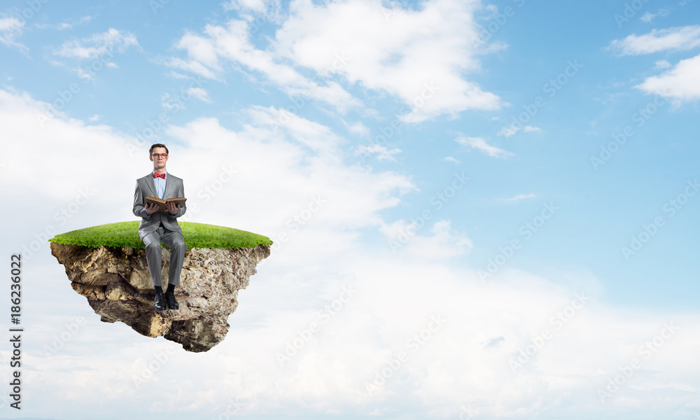 Young businessman or student floating in sky and studying the science