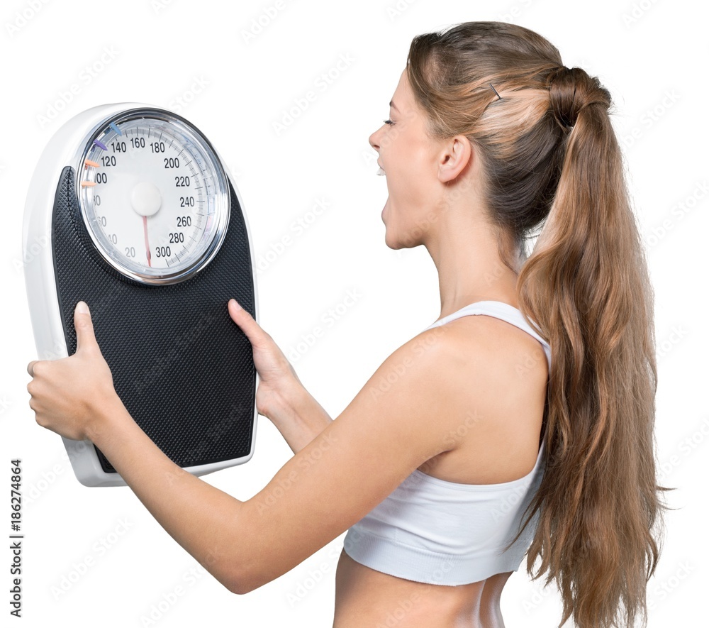 Portrait of a Fit Woman Shouting to a Weight Scale