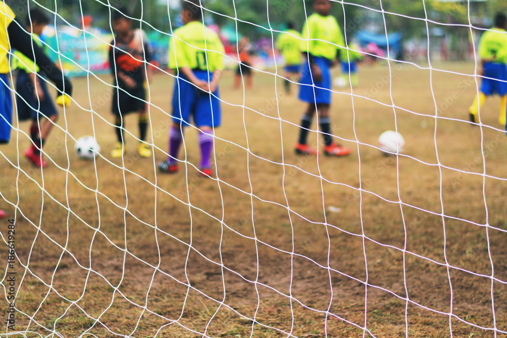 behind the soccer net with blure player background