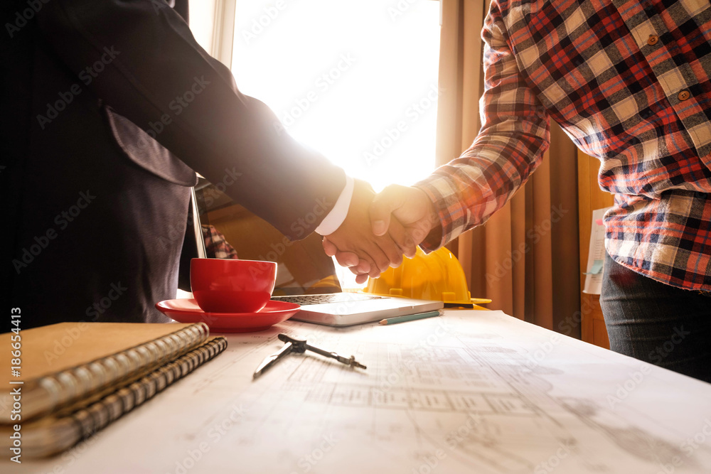 Two confident business man shaking hands during a meeting in the office, success, dealing, greeting 