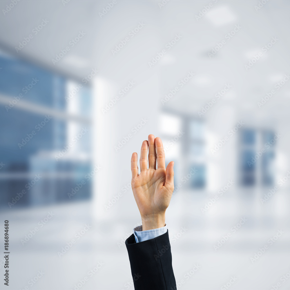 Choosing gesture of businessperson in elegant modern interior in sunshine light