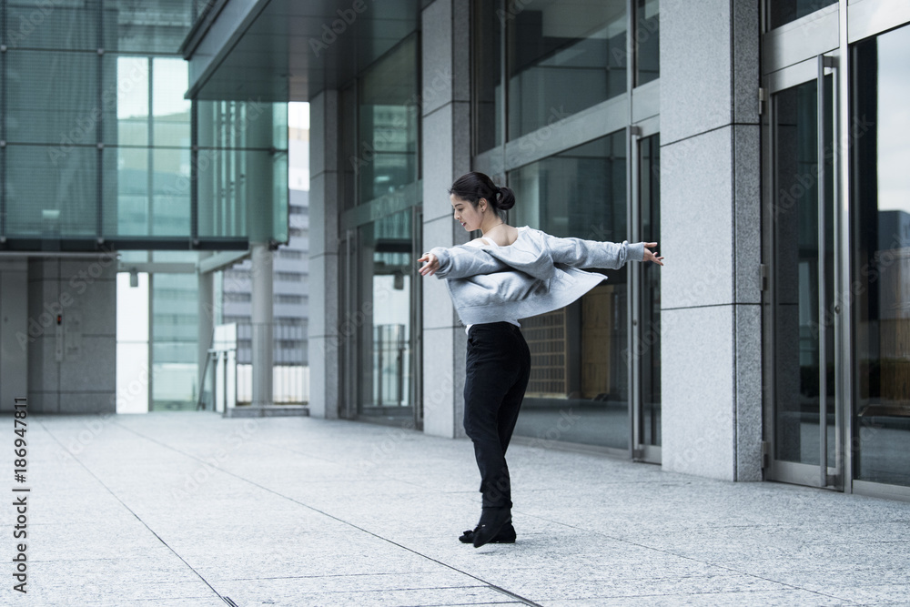 Dancer is practicing the choreography in the city