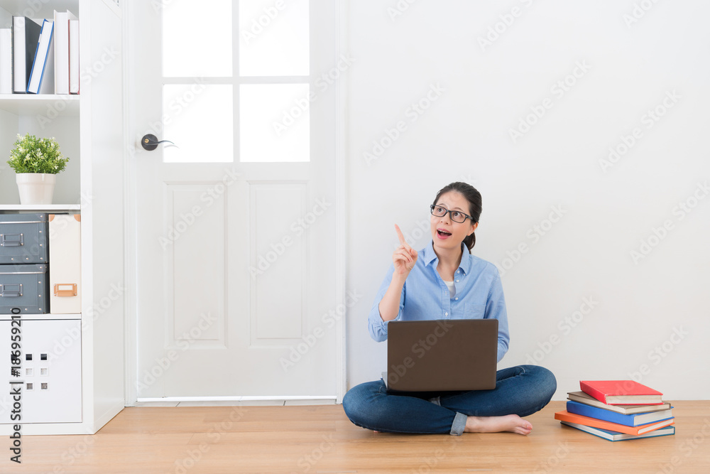 woman sitting on floor at home using computer