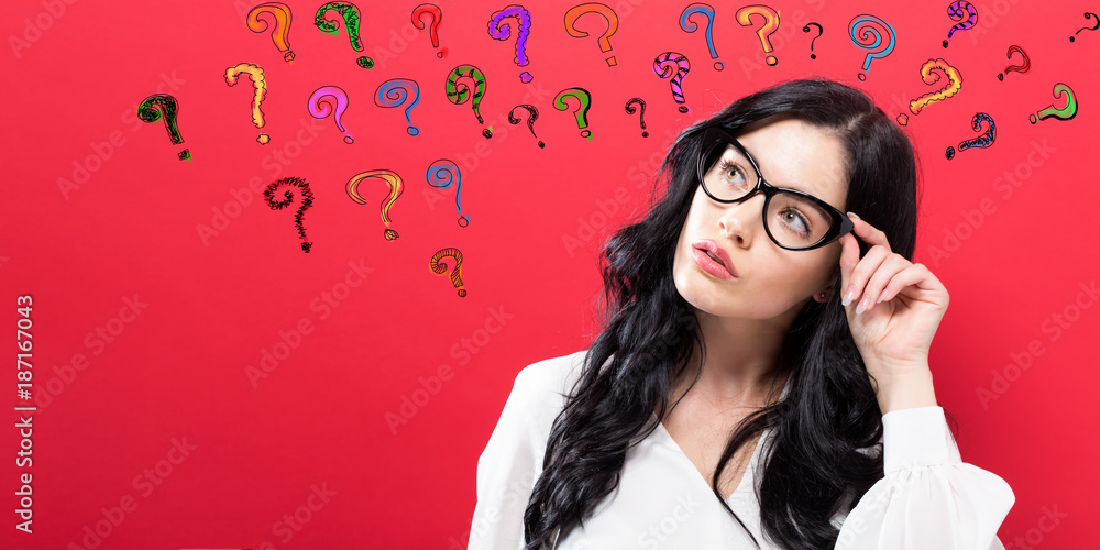 Young woman in a thoughtful pose with question marks