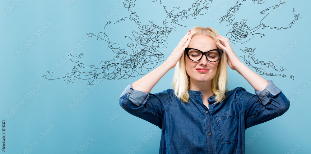 Young woman feeling stressed on a blue background