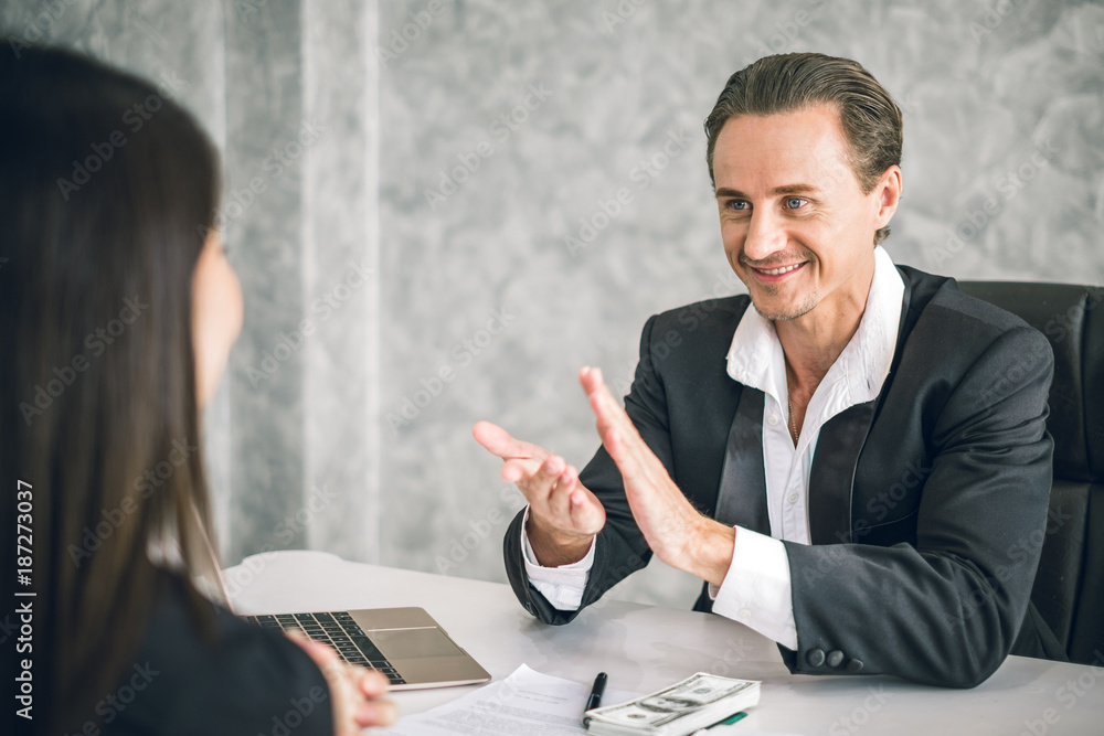 Boss/Business man employer admires young Asian business woman/staff/employee by thumb up and clap wi