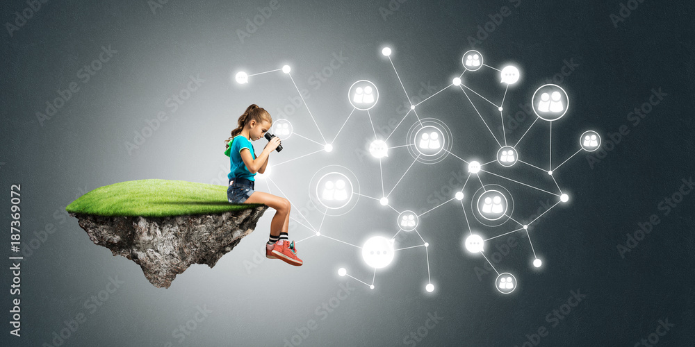 Concept of careless happy childhood with girl looking in binoculars