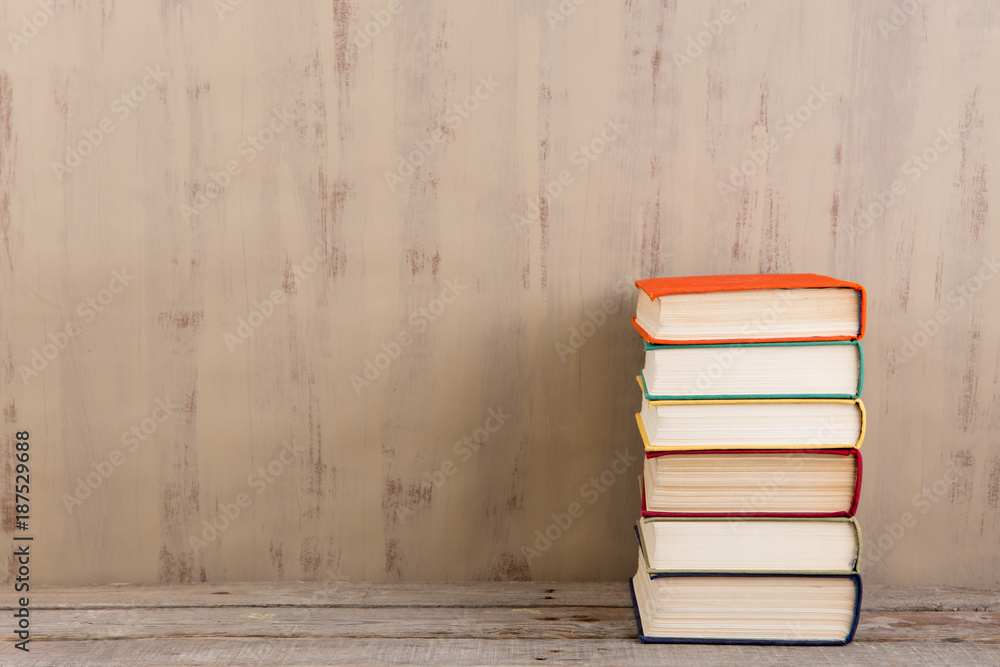 Education and reading concept - group of colorful books on the wooden table