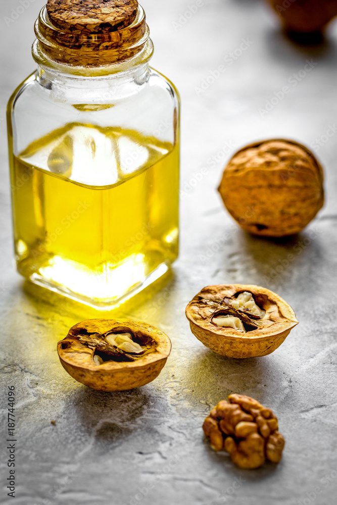 cosmetic and therapeutic walnut oil on gray background