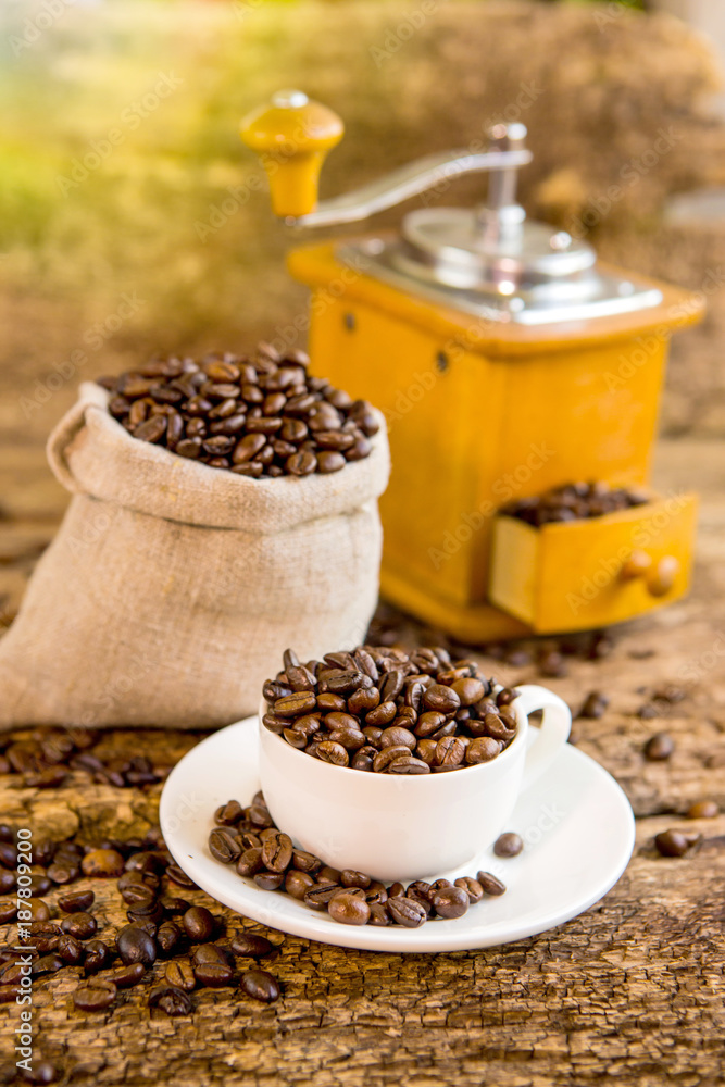 Cup of coffee beans. Coffee grinder and bag with coffee beans in the background. Coffee. Coffee bean