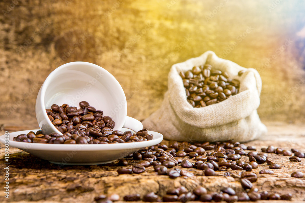 Coffee cup with coffee bag on wooden table. Coffee cup and coffee beans on a wooden table and sack b