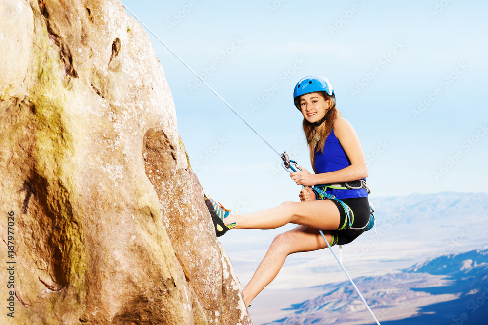 使用绳索下降法的女性登山者