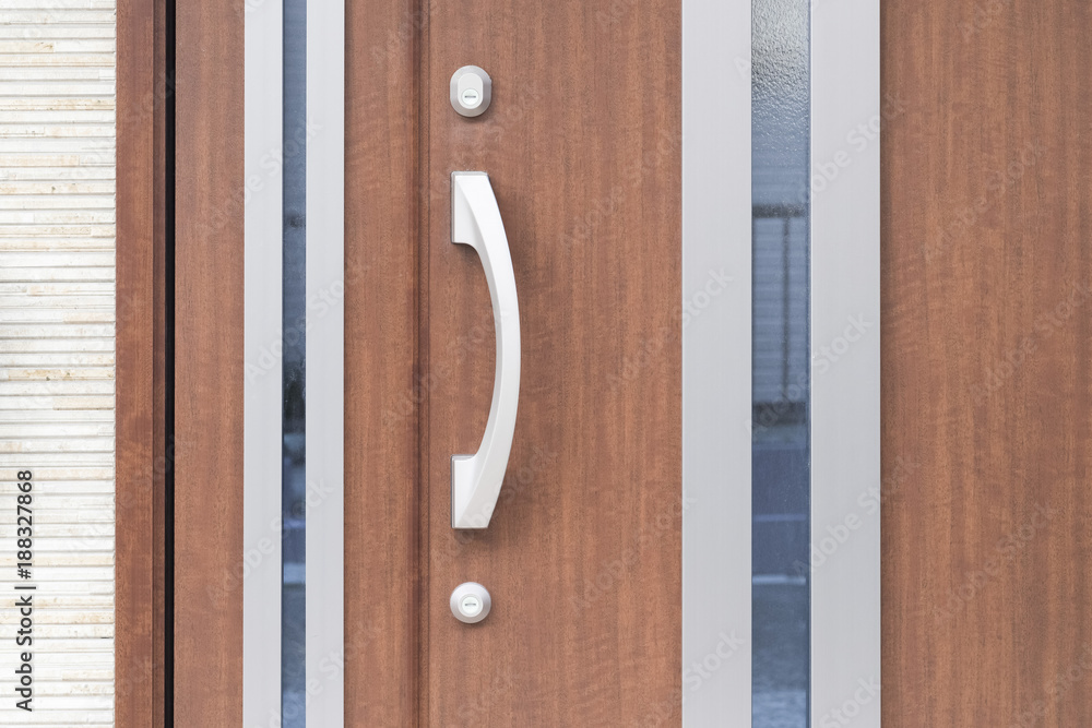 Silver metal door handle and brown wood door