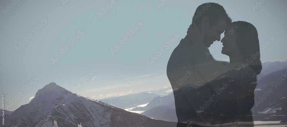 Composite image of couple wearing warm clothing embracing