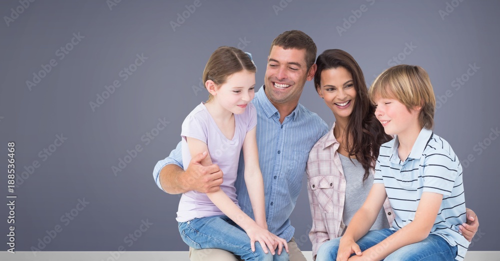 Family sitting together with purple background