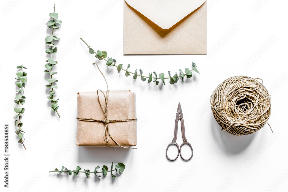 present design in box with flowers on white background top view