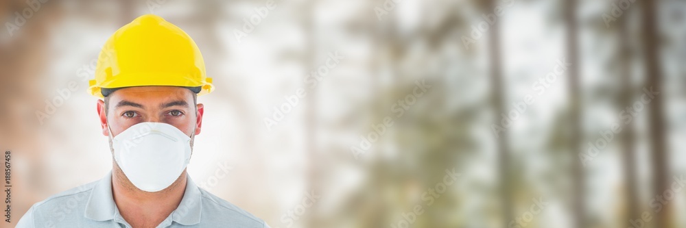 Construction Worker on building site by forest