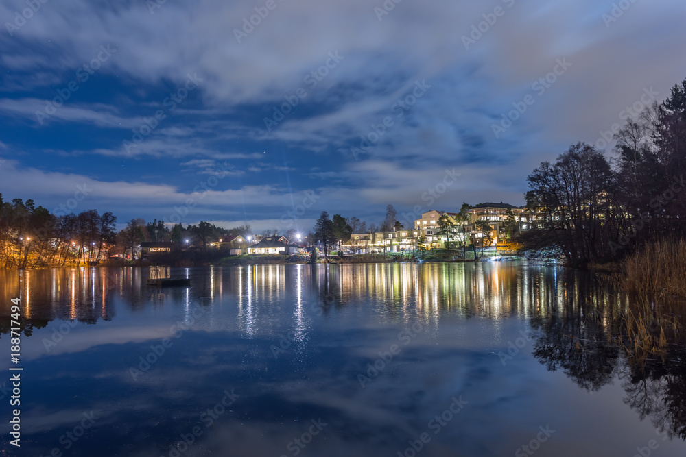 Nattvy över villor och hus vid en sjö i Skuru Stockolm