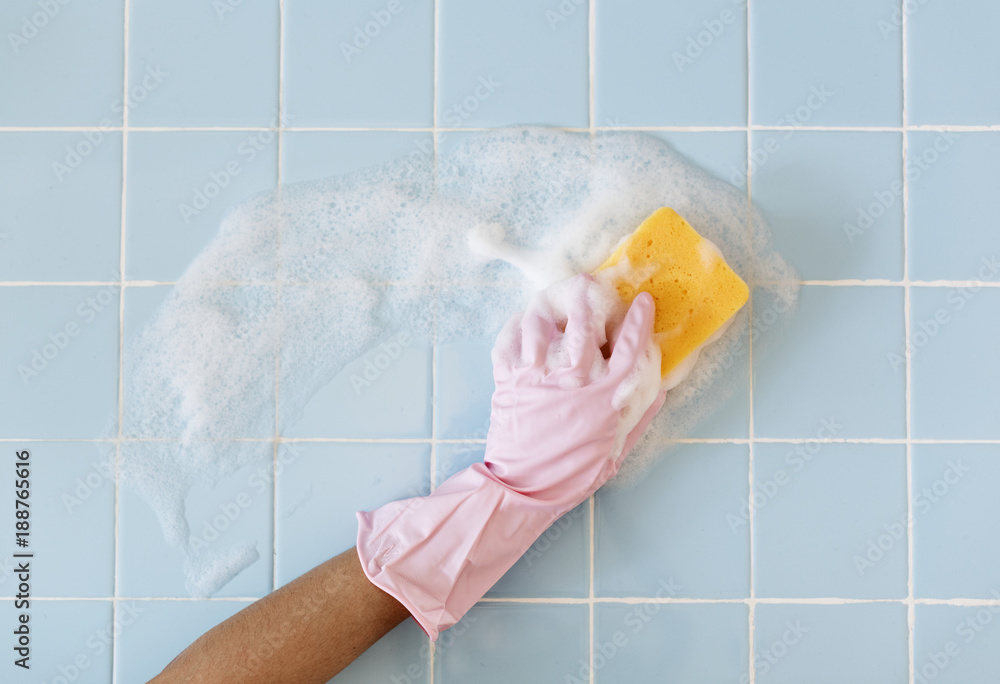 Hand in pink glove with sponge washing