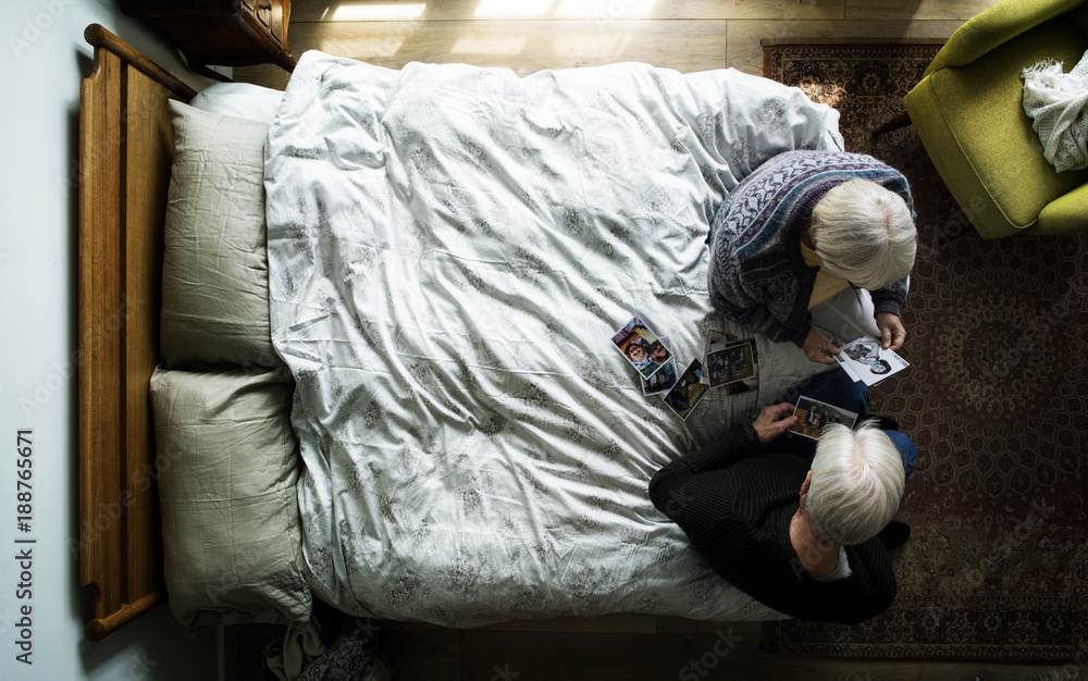 Elderly Couple sitting on the bed talking