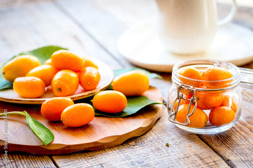 kumquat on plate at wooden table